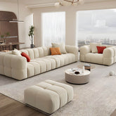 Beige upholstered wood sofa with square arms and sewn pillow back for modern living rooms
